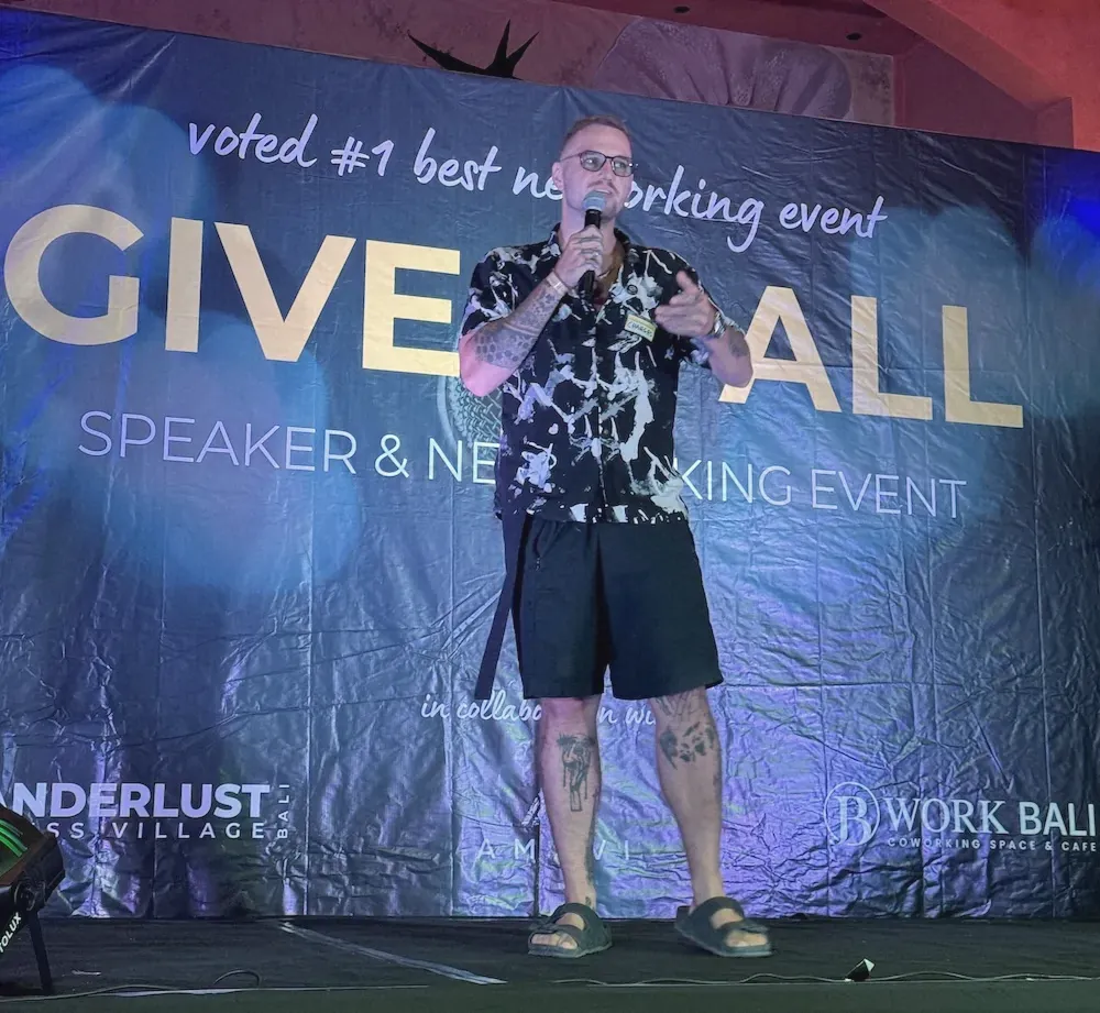 Dovydas Liaudanskas with a microphone on stage at Give It All in Bali